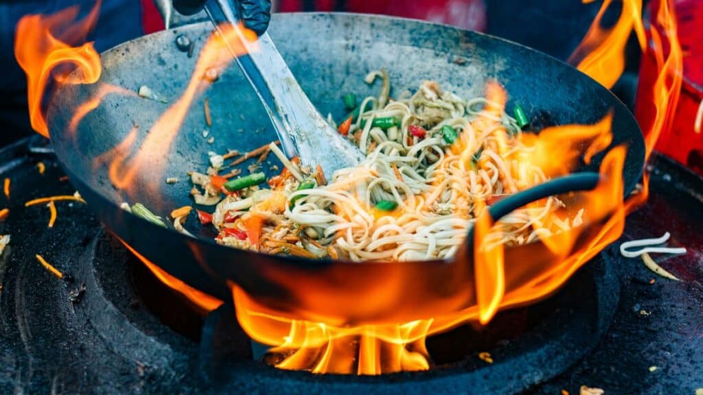 carbon steel wok on high heat fire