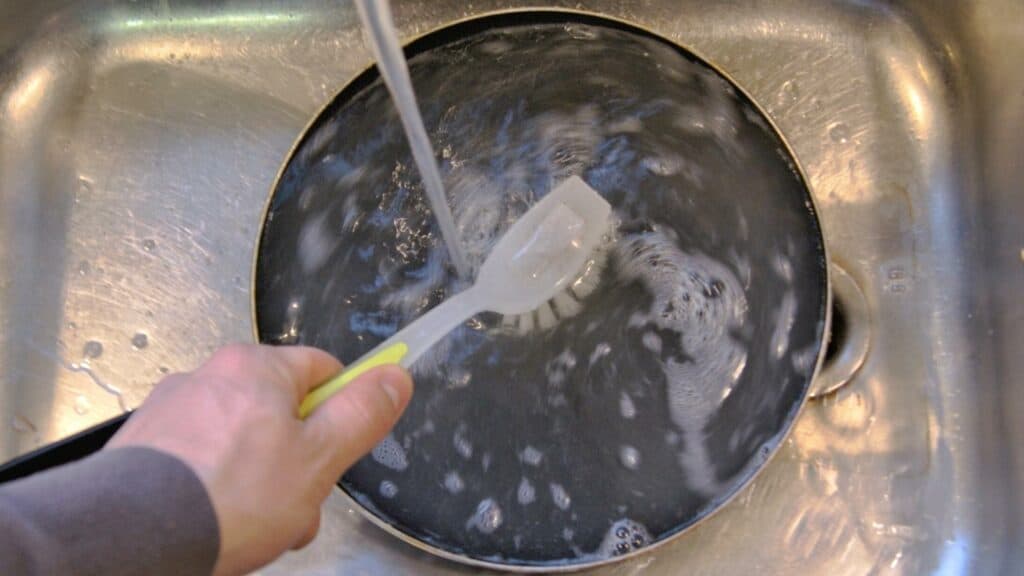 cleaning a pan in the sink