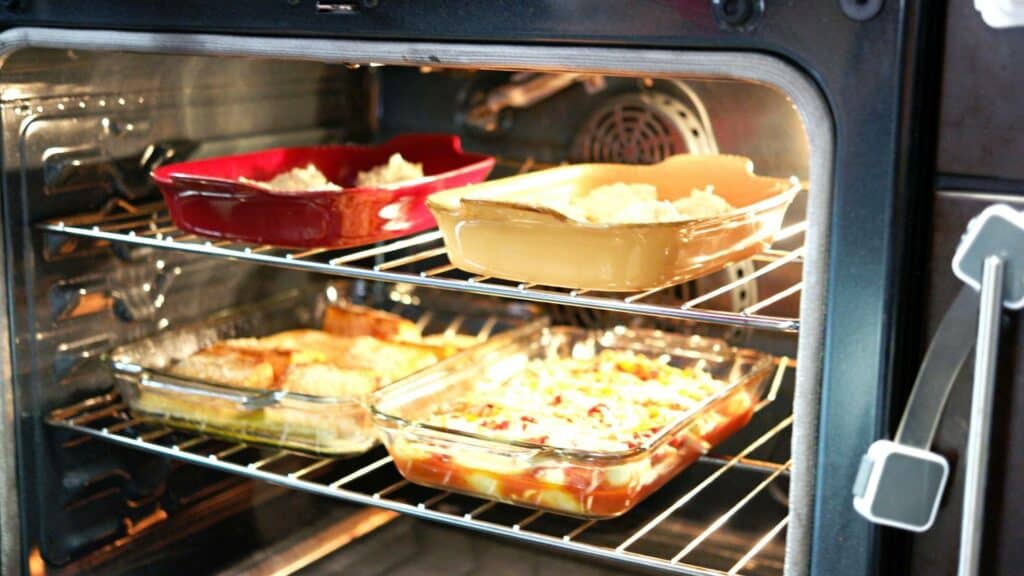 four glass dishes inside the oven