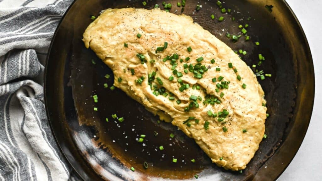 omelette with chives inside carbon steel pan
