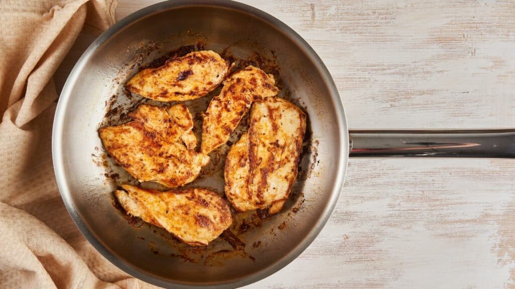 stainless steel pan with cooked chicken